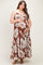 woman wearing a brown floral maternity maxi dress and holding her baby bump