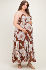 woman wearing a brown floral maternity maxi dress and holding her baby bump