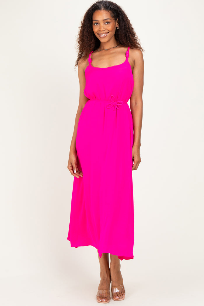 woman wearing a bright pink maxi dress with spaghetti straps and a drawstring waist