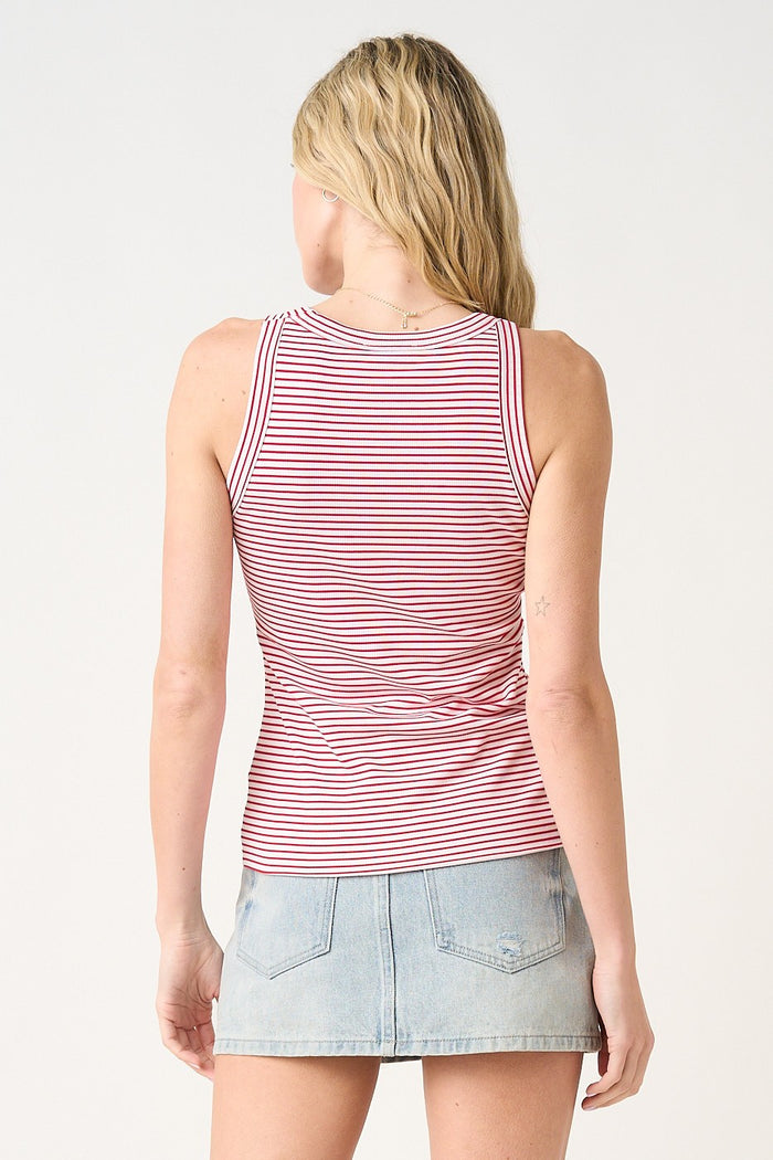 woman wearing a red and white striped tank top with a fitted style and back view, paired with a denim mini skirt