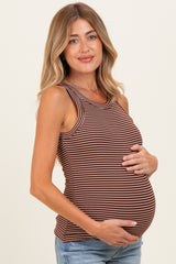 woman wearing a brown and cream striped maternity tank top, holding her baby bump