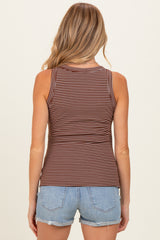 woman wearing a brown and cream striped maternity tank top, viewed from the back with denim shorts