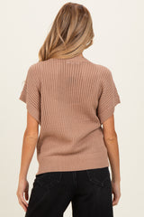 woman wearing a beige knit maternity sweater with short sleeves, shown from the back