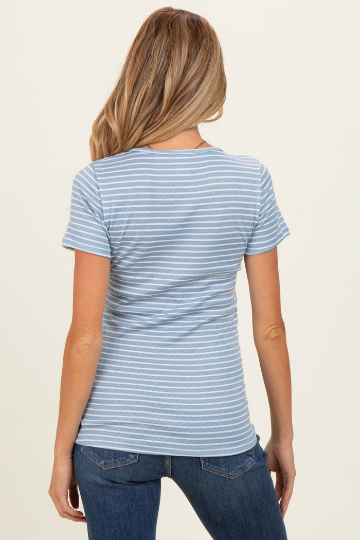 woman wearing a light blue striped maternity top with short sleeves and a fitted style, showing her back