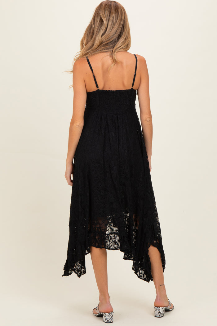 woman wearing a black lace maternity dress with adjustable straps and a high-low hem, showing a relaxed fit