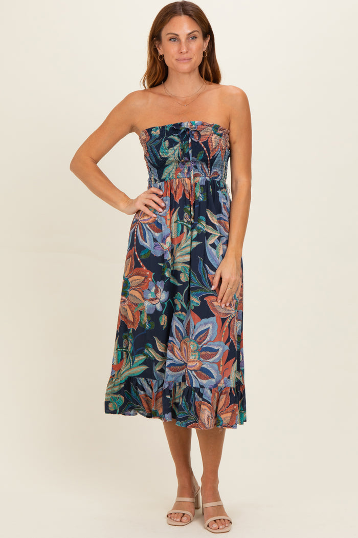 woman wearing a strapless floral print midi dress with a fitted bodice and flowy skirt