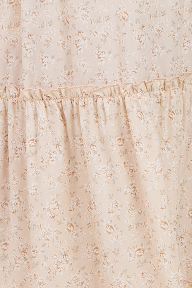 maternity wear in a light beige floral print with ruffles, suitable for expectant mothers