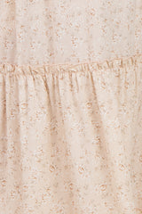 maternity wear in a light beige floral print with ruffles, suitable for expectant mothers