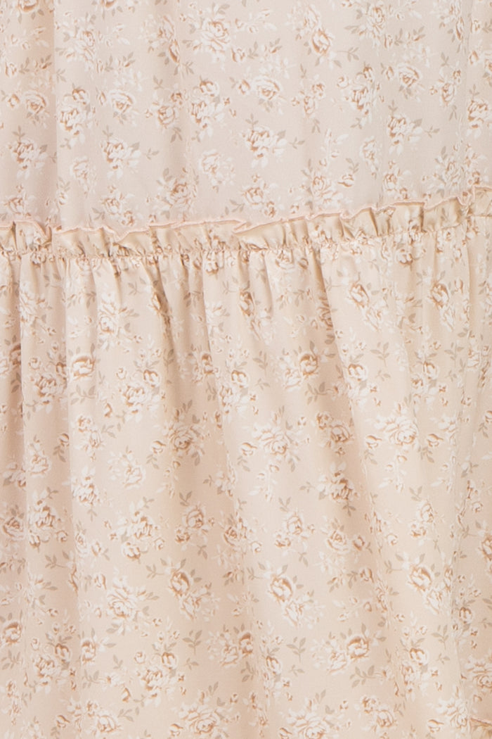 maternity wear in a light beige floral print with ruffles, suitable for expectant mothers