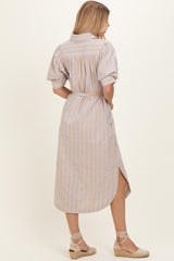 woman wearing a beige and blue striped button-up midi dress with short sleeves and a tie belt, shown from the back