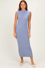 woman wearing a light blue ribbed maxi dress with a high neck and sleeveless design
