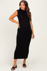 woman wearing a black sleeveless ribbed maternity dress, showing her baby bump, styled with open-toe sandals