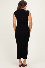 woman wearing a black ribbed midi maternity dress, sleeveless and fitted, with a subtle scoop neck design