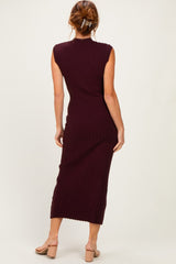 woman wearing a burgundy ribbed sleeveless midi dress, showing the back view, paired with light-colored sandals
