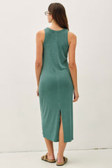 woman wearing a teal sleeveless midi dress with a side slit and a relaxed fit, viewed from the back