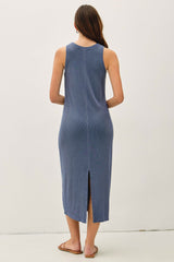 woman wearing a blue sleeveless midi dress with a back slit and a relaxed fit
