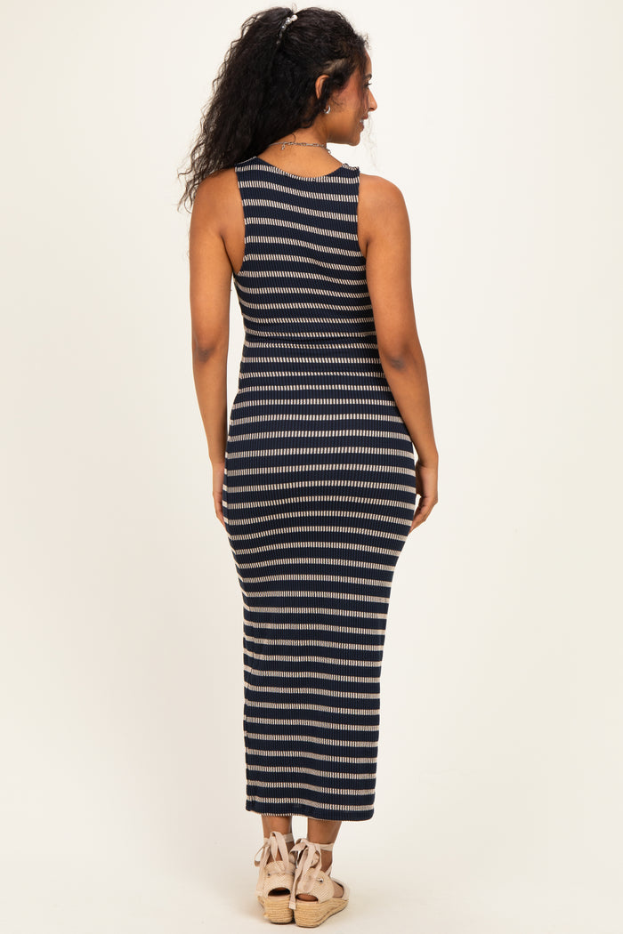 woman wearing a navy and cream striped maternity maxi dress, viewed from the back