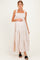woman wearing a light pink maternity maxi dress with ruffle straps and a smocked bodice, showing her baby bump