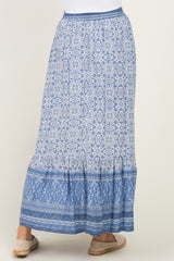 woman wearing a blue patterned maxi skirt with a tiered hem and elastic waistband