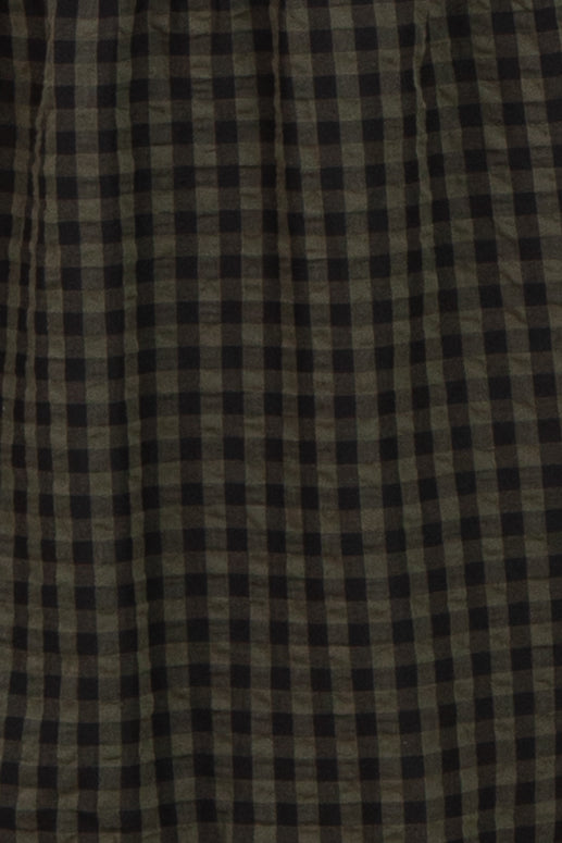 black and olive checkered patterned fabric draped softly