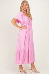 woman wearing a pink puff sleeve maxi dress with a drawstring front and tiered hemline