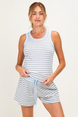 woman wearing a gray and white striped maternity tank top and shorts set, holding her baby bump