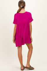 woman wearing a hot pink short sleeve maternity dress with a gathered waist, showing a relaxed fit