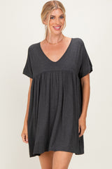 woman wearing a dark gray short sleeve tunic dress with a v-neck and gathered waistline