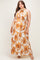 woman wearing a floral halter neck maxi dress in orange and white, showcasing her baby bump in this maternity wear