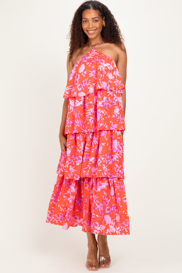woman wearing a red floral tiered maxi dress with spaghetti straps and a flowy silhouette