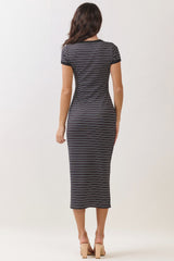 woman wearing a black and white striped midi dress with short sleeves, viewed from the back
