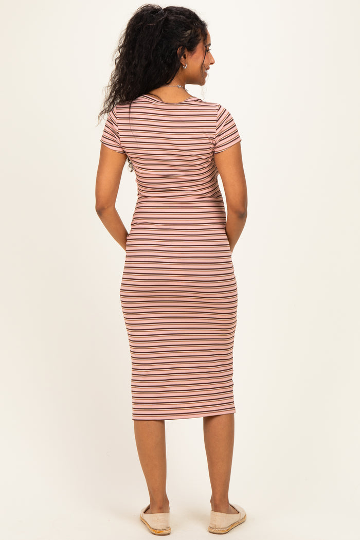 woman wearing a striped maternity midi dress with short sleeves and a fitted silhouette, showcasing her baby bump from the back