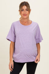 woman wearing a lavender short sleeve maternity top with a relaxed fit and a round neckline, showing her baby bump