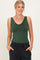 woman wearing a green sleeveless v-neck bodysuit with a relaxed fit and pockets in black pants