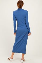 woman wearing a long sleeve blue midi dress with a fitted silhouette and back slit