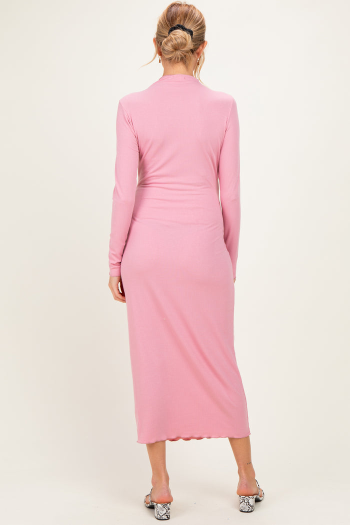 woman wearing a light pink long sleeve maternity dress with a fitted silhouette and back seam detailing