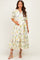 woman wearing a floral printed maternity dress with a tie waist and tiered ruffle hem, showing her baby bump