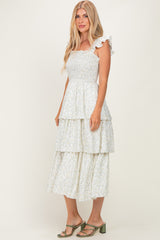 woman wearing a white floral tiered midi dress with ruffle straps and a smocked bodice