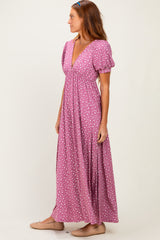 woman wearing a purple maxi dress with white polka dots and puff sleeves standing sideways