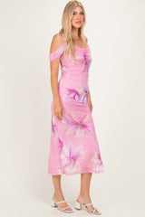 woman wearing a pink floral off-shoulder midi dress with a fitted bodice and flowy skirt