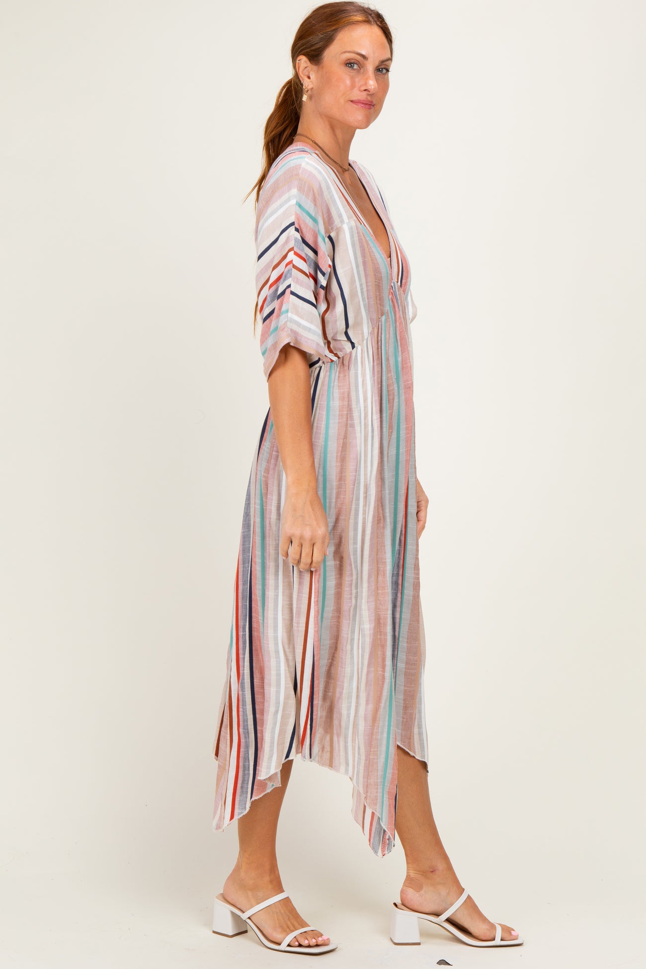 woman wearing a multicolor striped midi dress with short sleeves and a high-low hemline