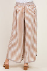 woman wearing striped wide-leg pants in tan and white with an elastic waistband