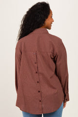 woman wearing a brown and white checkered maternity shirt with button details on the back