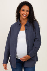 woman wearing a navy checkered maternity shirt over a white tank top and showing her baby bump