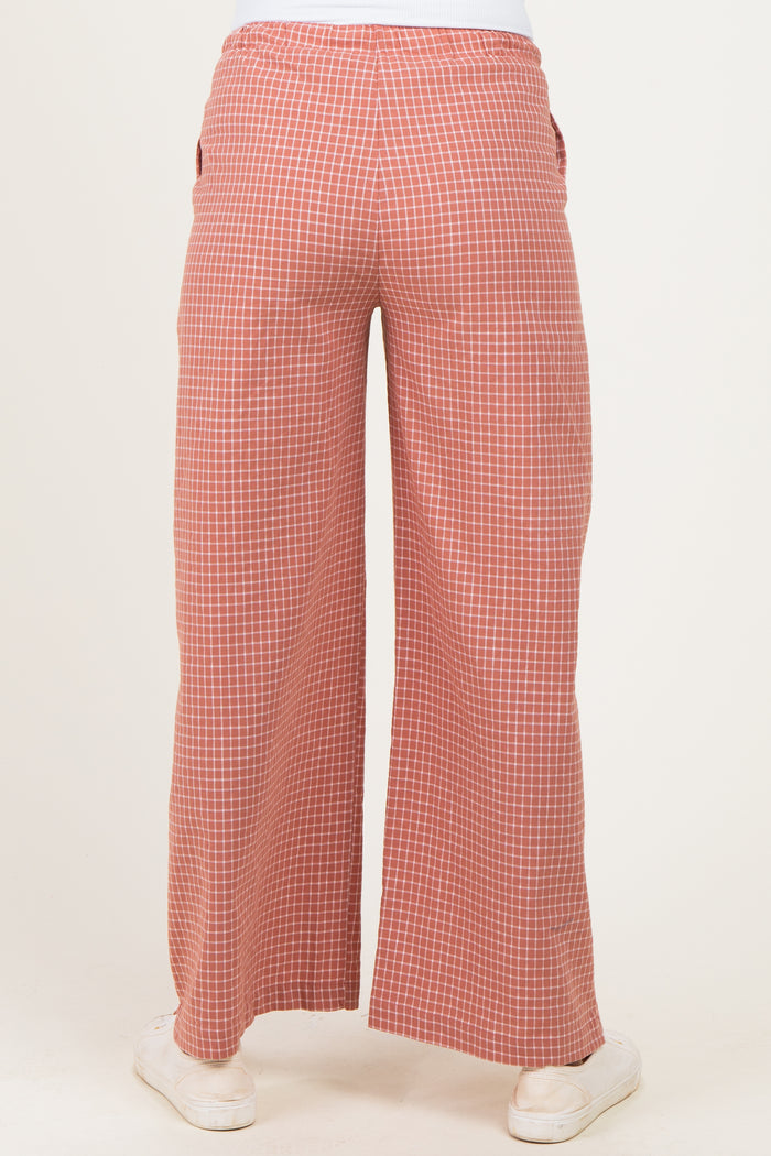 woman wearing red and white checkered maternity wide-leg pants, viewed from the back