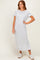woman wearing a light grey short sleeve maxi dress styled with casual white sneakers