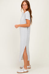 woman wearing a gray short sleeve maxi dress with side slits and white sneakers