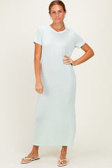 woman wearing a light mint green short sleeve maxi dress with a relaxed fit and round neckline