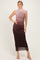 woman wearing a sleeveless ombre maxi dress transitioning from light brown to dark brown, posing with one hand on her hip