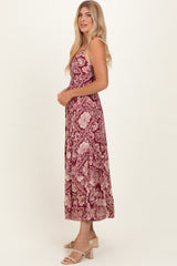woman wearing a burgundy floral midi dress with a fitted bodice and flowy skirt, styled with nude block-heeled sandals